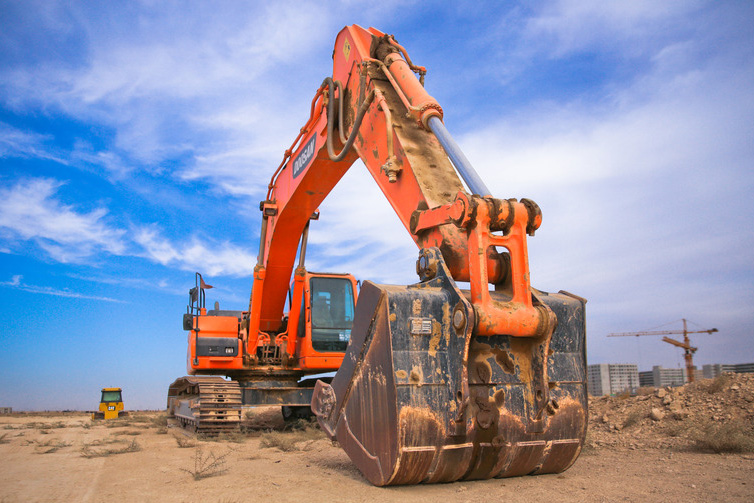 canva-low-angle-photography-of-orange-excavator-under-white-clouds-MADGvs-Y7Mw